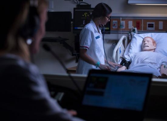 澳门新普京注册 Nursing student treating test patient. 